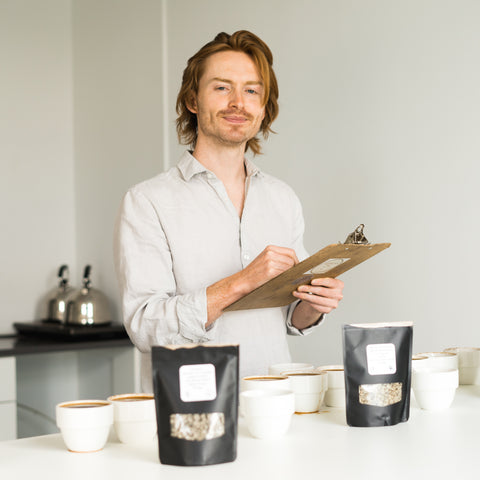 Cole Torode smiling in his cupping lab