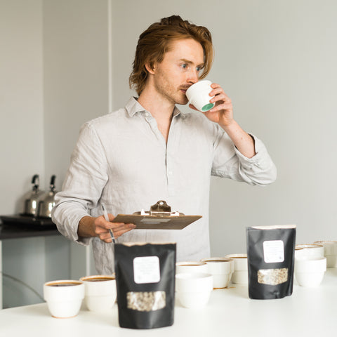 Cole Torode sipping cupping coffees 