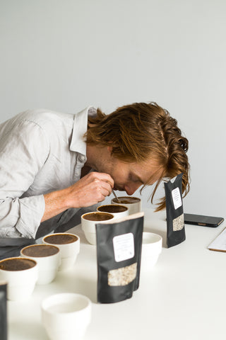 Cole Torode cupping and smelling coffee 