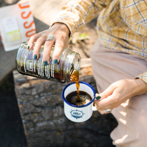 Pouring Aeropress coffee in camping mug