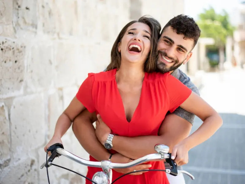 couple happy riding a bike together