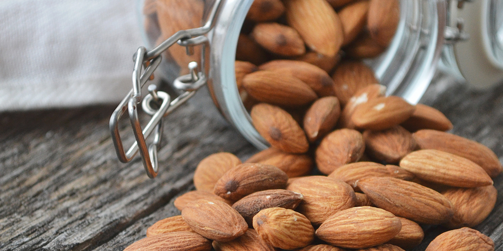 almonds spilling from a glass jar