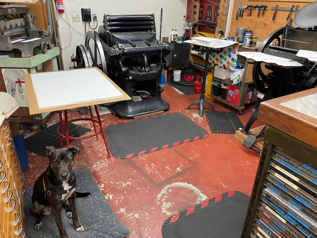 letterpress print shop mid-press run on a Colt's Armory Press with dog