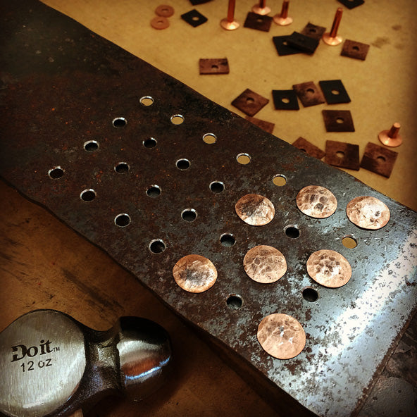 Hammered heads of copper rivets