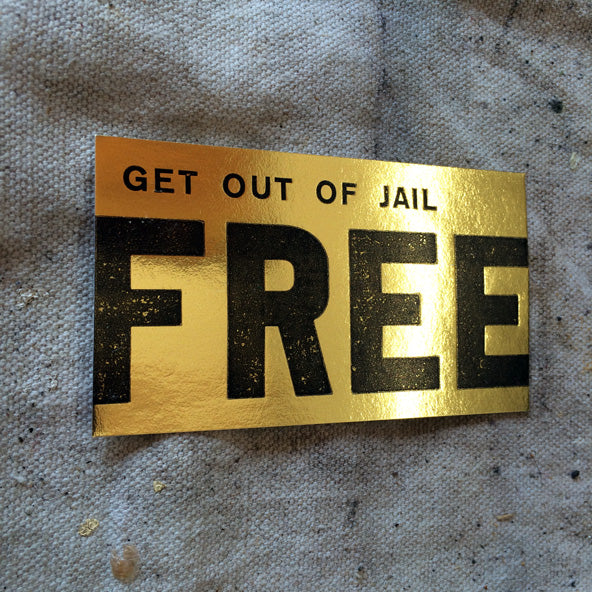 "get out of jail free" printed on gold foil card