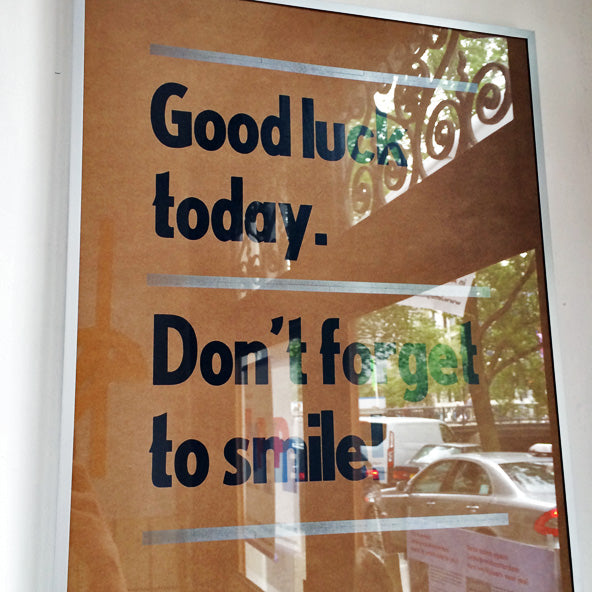 letterpress poster reads "Good luck today. Don't forget to smile."