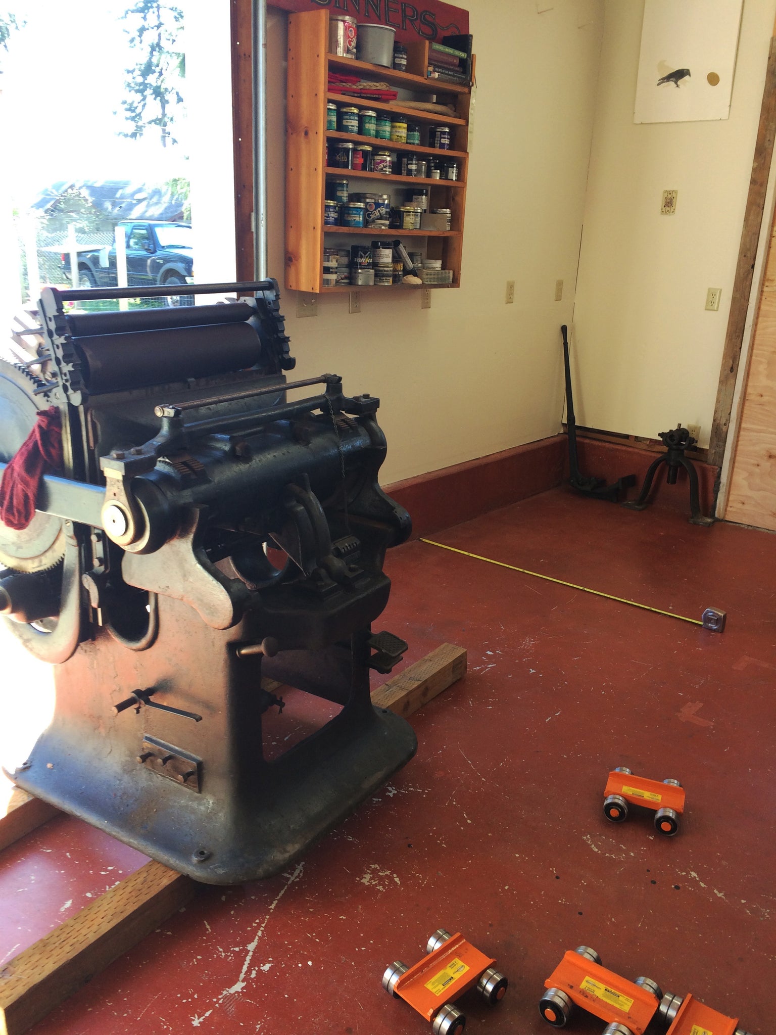 printing press moving into shop with red floor