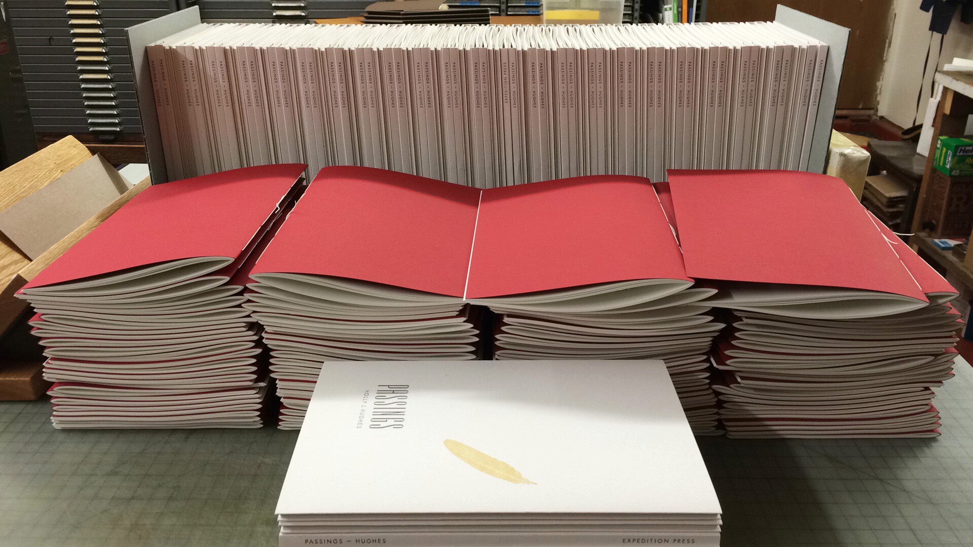 red insides of books with white covers behind