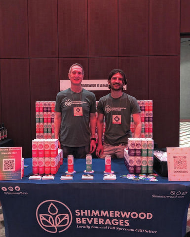 Founders posing behind the Shimmerwood branded table