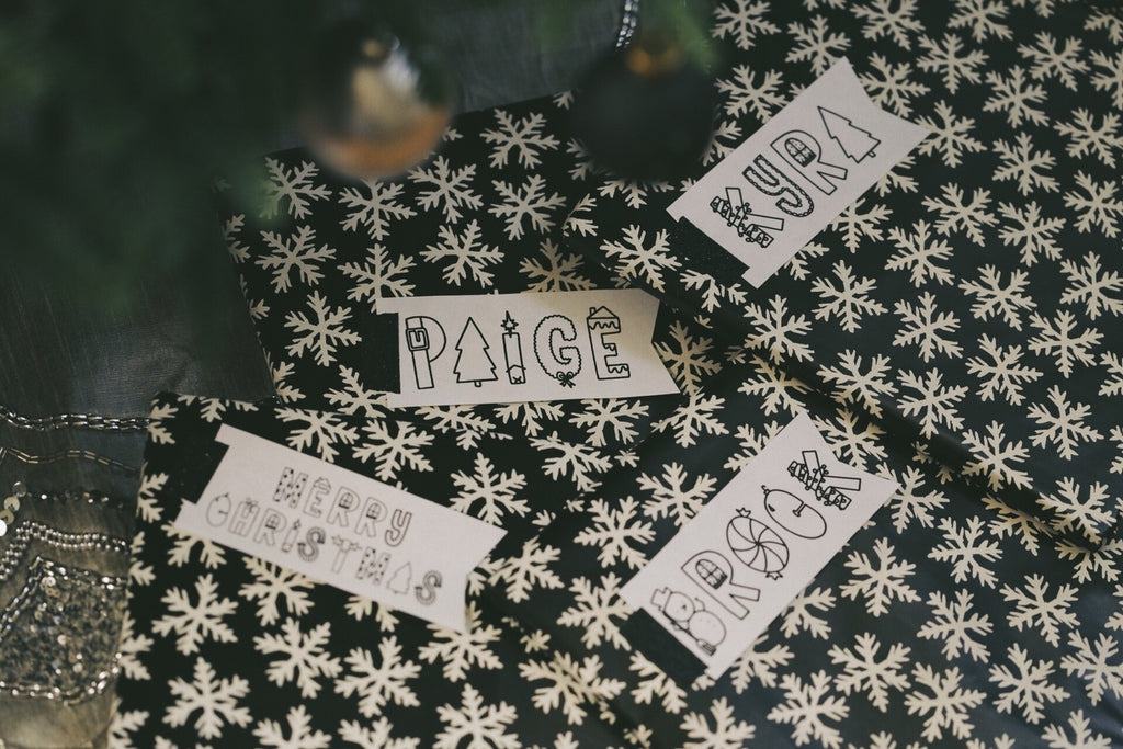 Four gift tags on presents with Rad Tidings font
