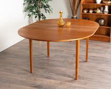 Load image into Gallery viewer, Vintage Teak Round Dining Table with Hidden Leaf
