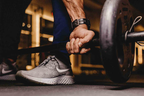 Hand clenched lifting a barbell