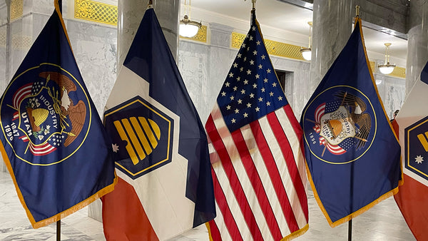 Utah's New Flag displayed alongside the now ceremonial utah flag and the ameican flag