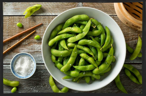 bowl of cooked edamame beans sprinkle with sesame seeds and sea salt