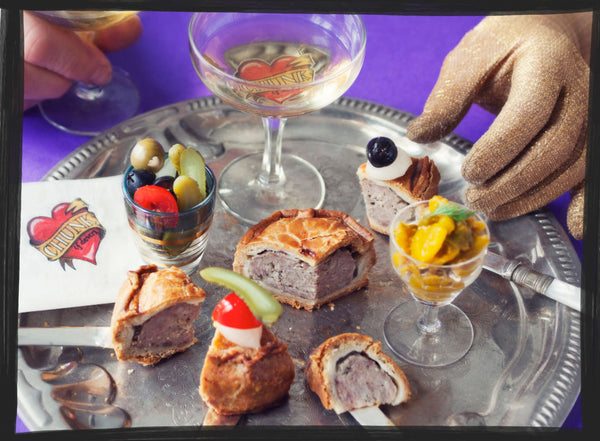 silver party platter serving of pork pies and champagne