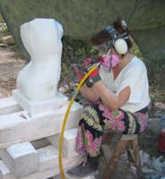 Using her Bantam pneumatic chisel, artist Kelly Borsheim carves marble, refining the sensual curves of the torso