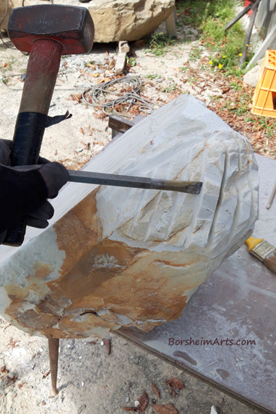 Shaping the skull first by scoring the marble in parallel lines then to take a hammer and chisel and knock away between the lines