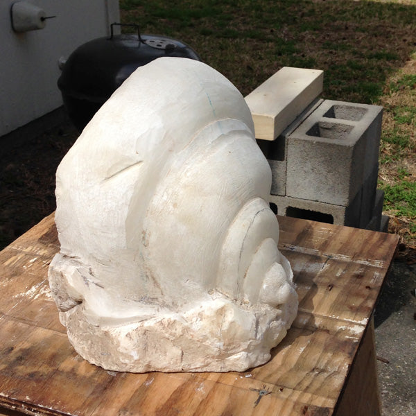 Abandoned sculpture in alabaster stone shell form, later carved into a gypsy portrait by George Schreiber