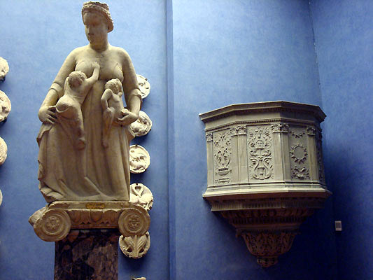 museum quality old statue and pulpit in art collection of the blue walled Bardini Museum in Florence, Italy