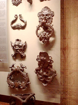 Collection of bronze door knockers, some with human heads Bardini Museum Florence Italy