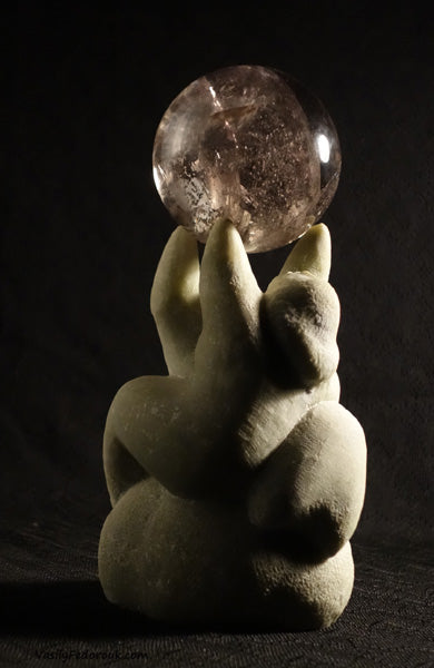 stone and glass crystal ball as a couple reaches to hold up the world sculpture by Vasily Fedorouk