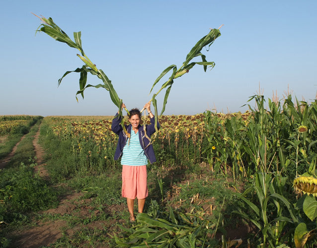 2012:  Dragana Adamov uses cornstalks as antlers, farm in Serbia.