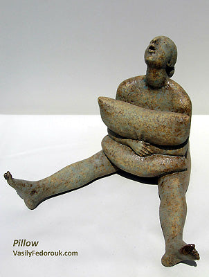 Pillow, a figure squeezes a pillow to her torso while her legs are spread out horizontally in front and she looks to heaven, ceramic sculpture