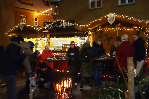 Small German Christmas market for Gluhwein and bratwurst in the Fuggerei Augsburg Bavaria