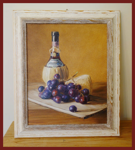 12 x 9 inch framed in white distressed wood of a Chianti wine bottle next to a cutting board of grapes and Parmesan cheese. lovely traditionally painted oil, realistic.