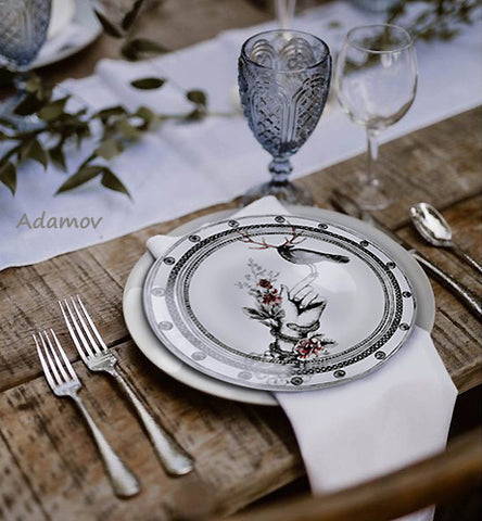 Elegant designer plate Bird on the Hand is shown here with an eclectic table setting.  Plate design and artwork by Dragana Adamov