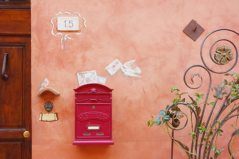 Photo of a warm rose and off-white colored mural in Tuscany of birds delivering mail to an Italian home.  Available as a digital download pair of photographs by Kelly Borsheim