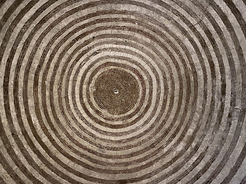 Concentric circles of a light and dark versions of stones or brick make up the dome in the chapel of San Galgano, Siena, Tuscany