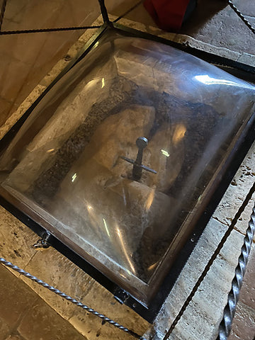 a window now protects the ancient sword embedded in a rock in San Galgano, Siena, Tuscany