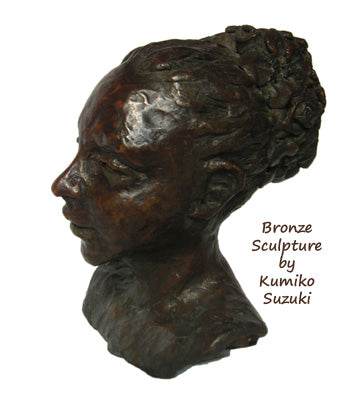 small one of a kind bronze portrait of a woman with a large bun piled up and behind her head. art by Kumiko Suzuki