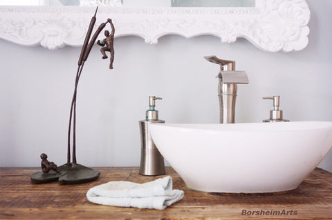 The Unwritten Future, bronze sculpture of two men on a lily pad and cattails, set in a contemporary bathroom