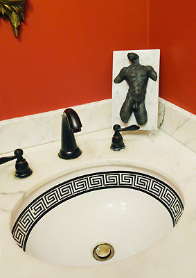 Black patina on bronze sculpture of male nude torso, Valentine, with white marble back looks great in black, white, and red bathroom