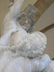 Soldier man raises his arm to hit a woman pleeing with him.  Sculptor Pio Fedi