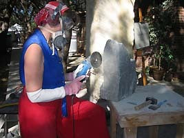 Sculptor Kelly Borsheim cuts stone Fish Lips with Diamond Blade. Photo by Jim Cayton.