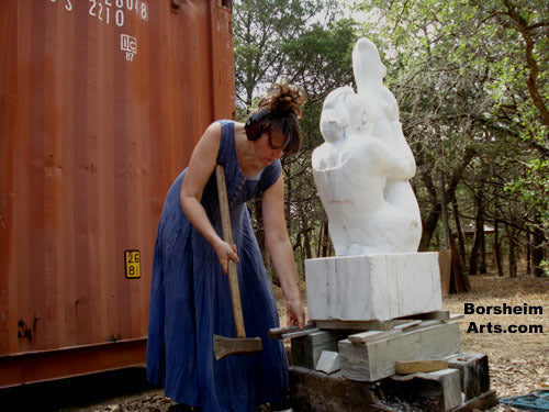 Sculptor Kelly Borheim raises her marble block to work with her back straight on lower parts of sculpture