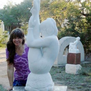 Sculptor Kelly Borsheim with her stone carvings Gymnast and Stargazer Marble Statues