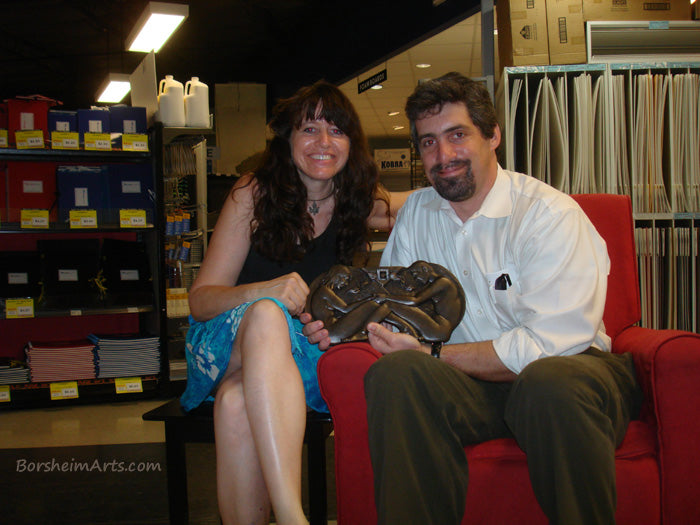 Artist Kelly Borsheim with client husband Jim with his 8th wedding anniversary gift for his wife with bronze sculpture.
