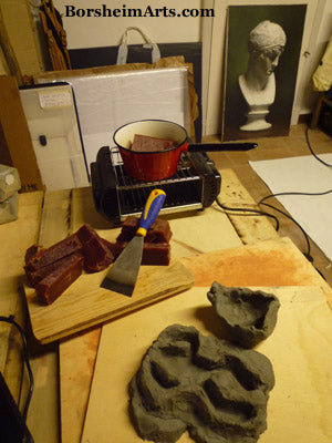 quick temporary molds shaped from clay to pour the beginning wax forms for frogs