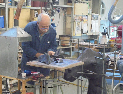 Raimondo cleans wax to prepare bronze casting.
