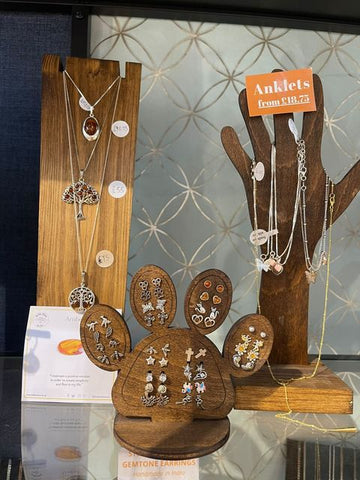 various plywood jewellery displays in a shop display case