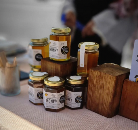 Jars of honey displayed on wooden blocks
