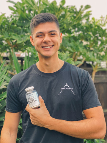 Our founder holding our daily vegan multivitamin