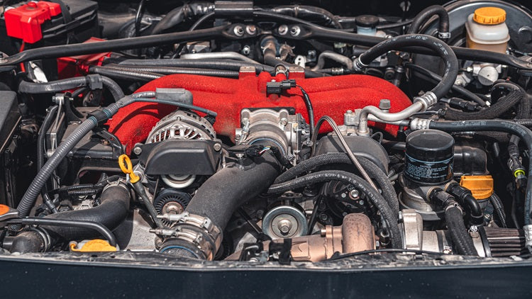 What are the symptoms of a worn exhaust manifold?