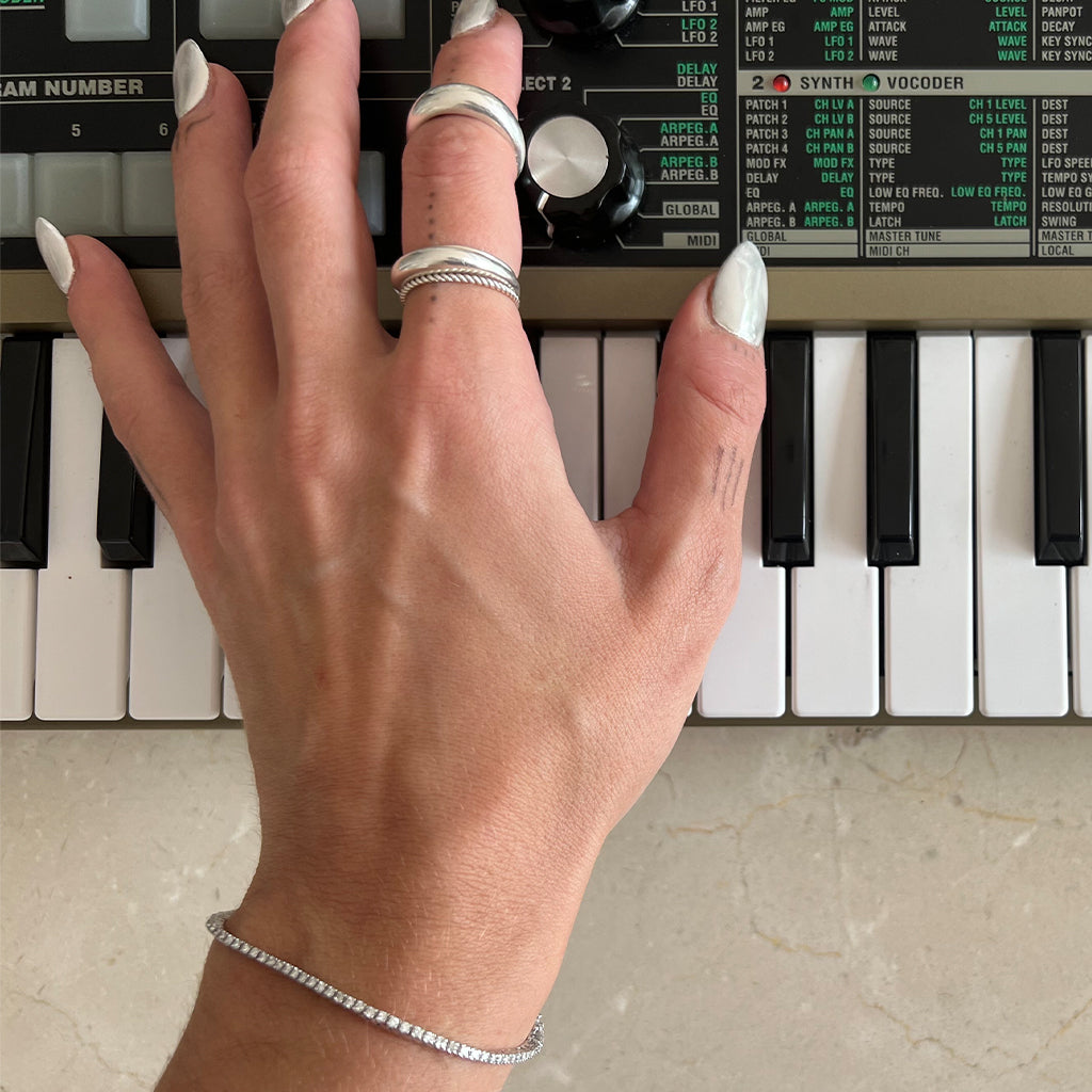 Elodie's hand wearing jewellery