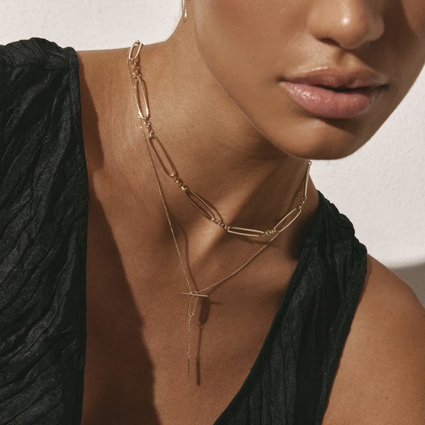 Lariate necklace styled with paperclip necklace in gold