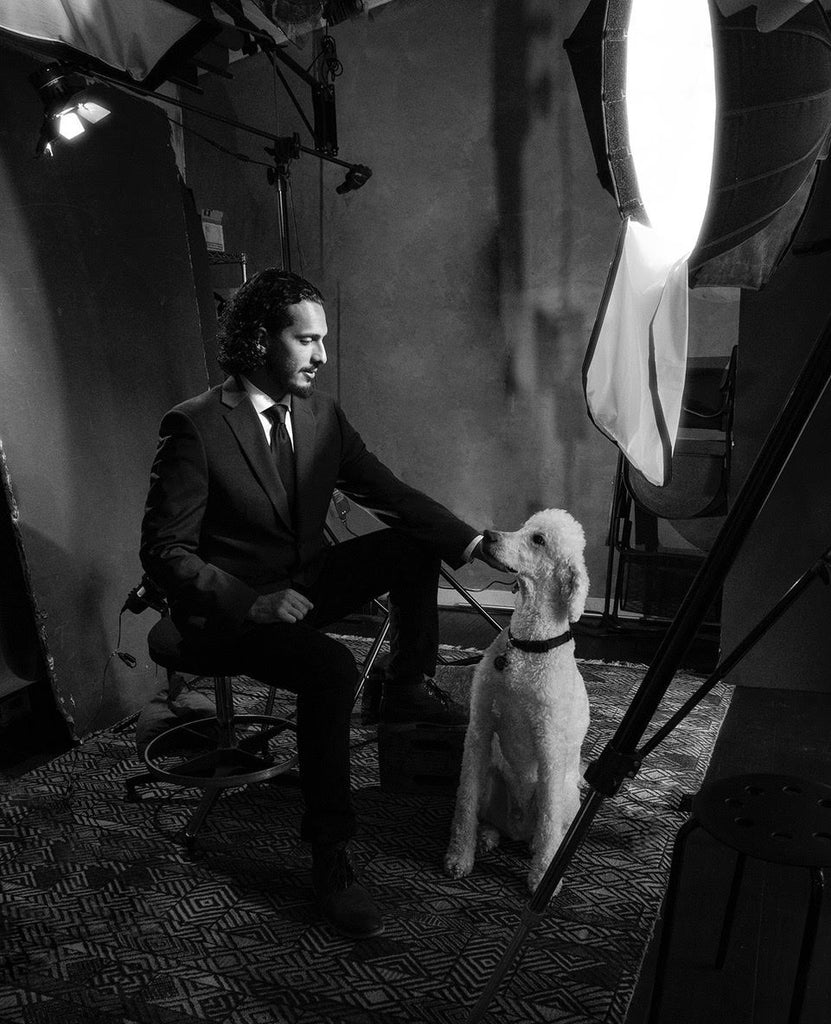 Alan Weissman portrait of man in suit with white standard poodle